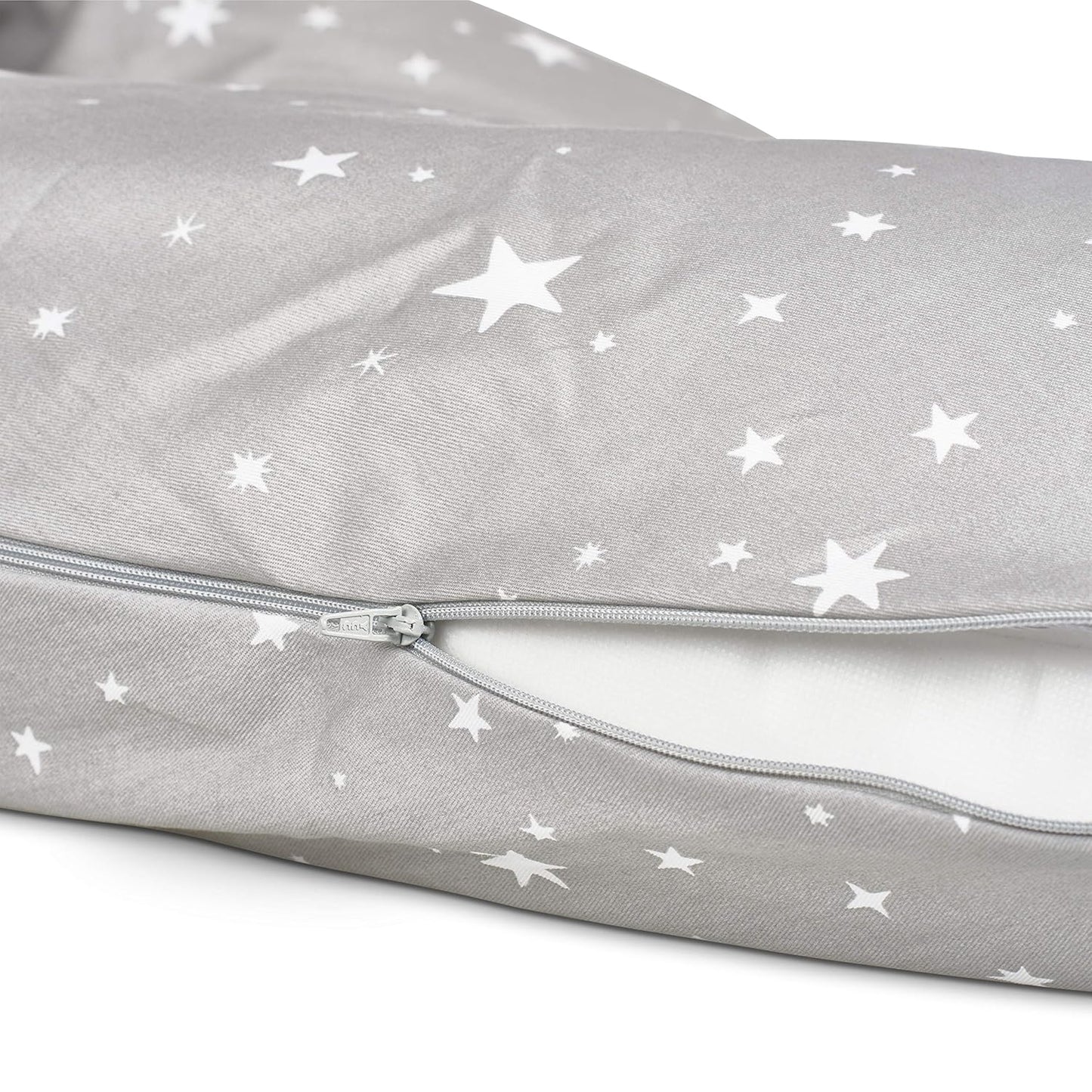 Close-up of Medela nursing pillow partially open to show soft inner filling.