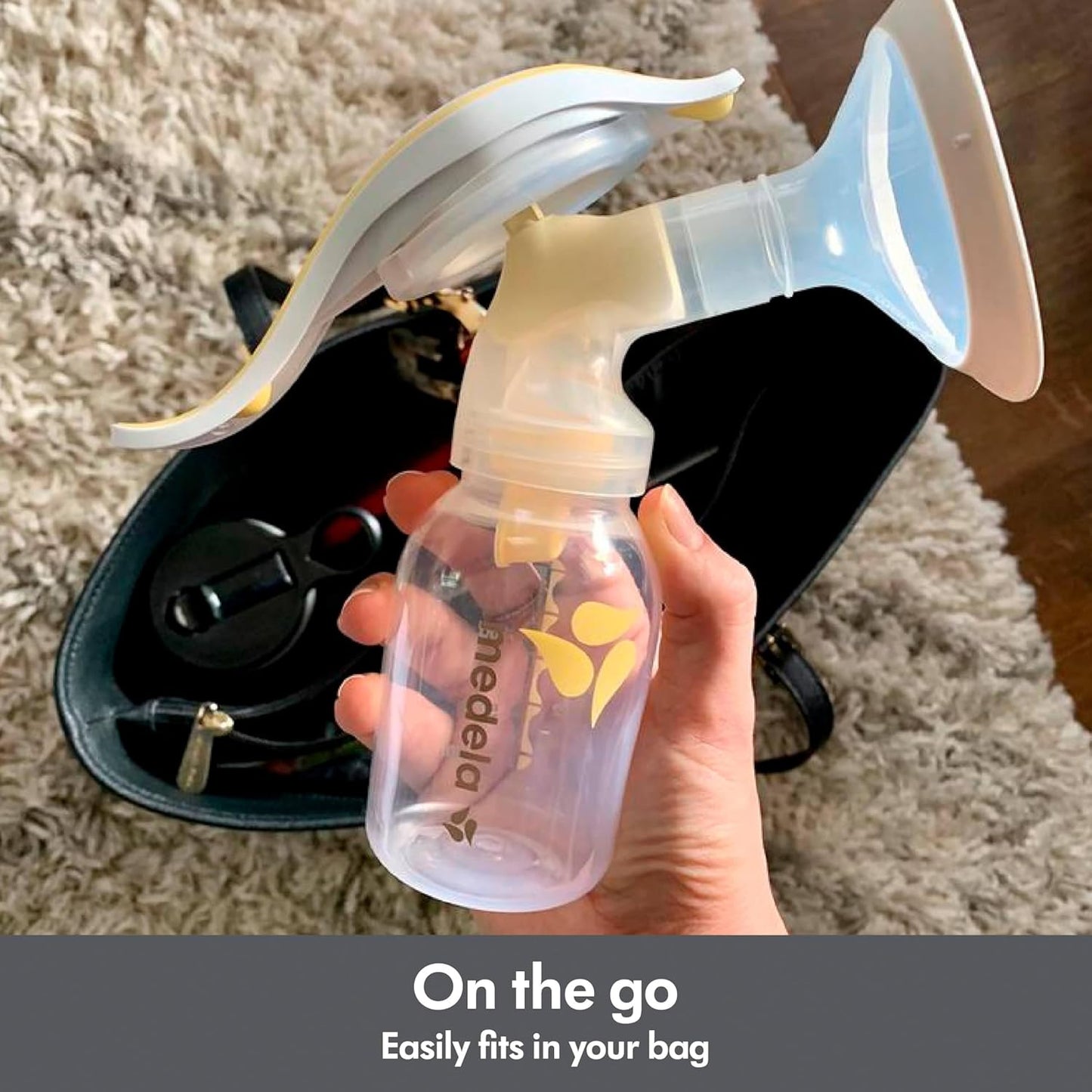 Medela Harmony Breast Pump Being Placed in Handbag, Easily Fits for On-the-Go Convenience