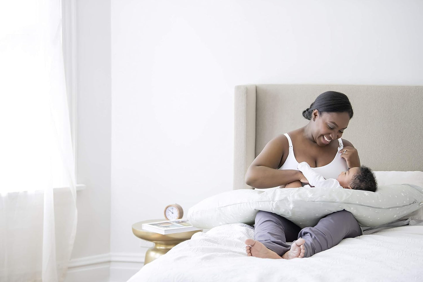 Mom feeding baby with Medela nursing pillow