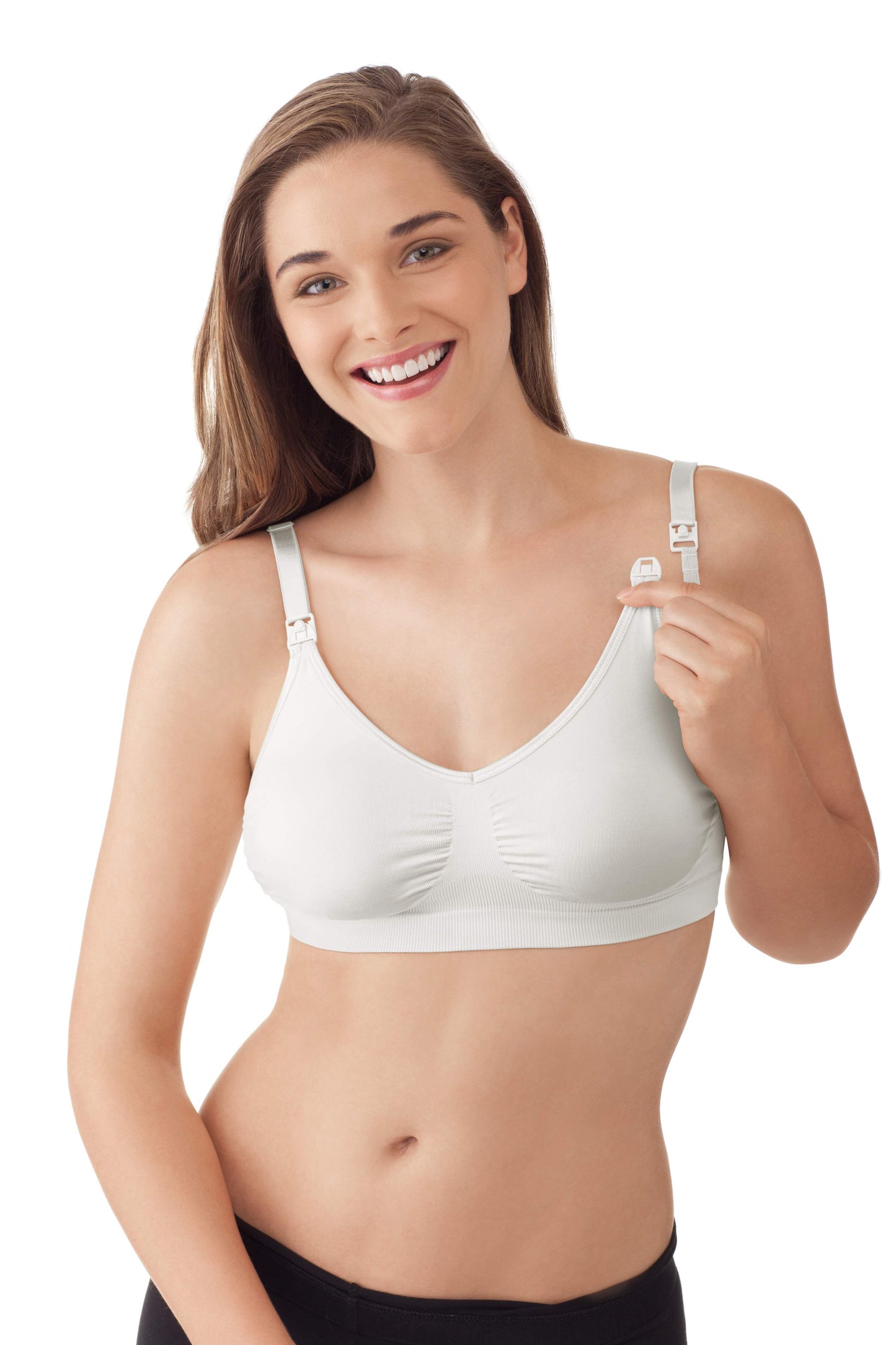 Woman wearing white Medela nursing bra demonstrating easy-access clip feature.