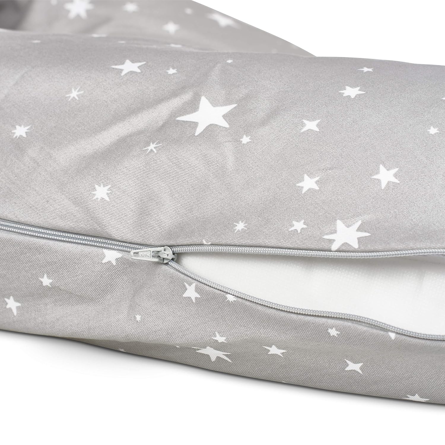 Close-up of Medela nursing pillow partially open to show soft inner filling.