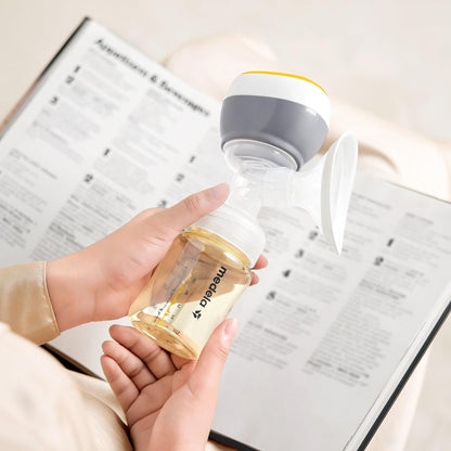 Medela Easy Breast Pump Held in Hand, Showing Compact and Ergonomic Design