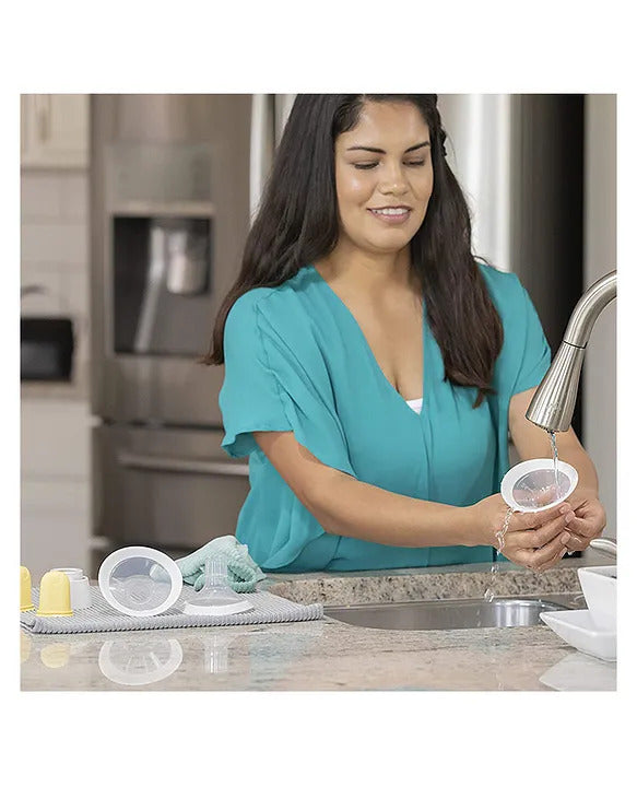 Mom cleaning the Medela breast shield, ensuring hygienic and safe use for breastfeeding