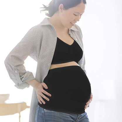Mom wearing Medela black supportive belly band, showing comfortable and flexible fit.